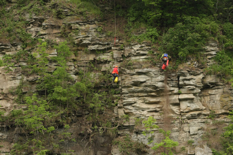 Geologists mapping rock face