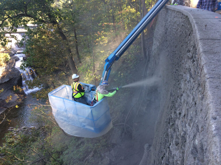 Applying Shot-Crete to repair retaining wall