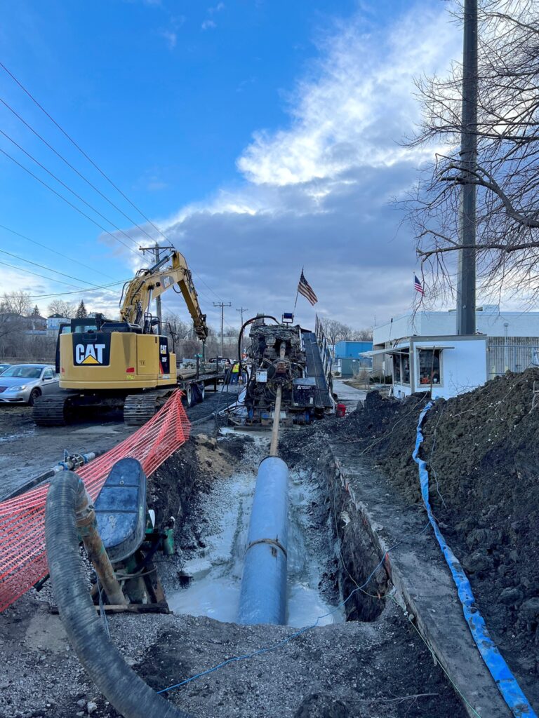 HDD Rig pulling new Vine St water main pipe beneath the Des Moines River, Ottumwa,IA